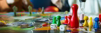 Board game tokens and dice on a board game.