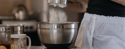 Gluten Free Bakers - Sifting Flower into a mixing bowl - Blog Banner