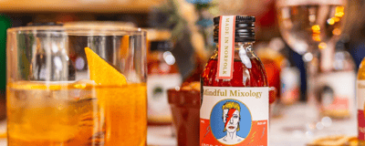 a glass and bottle of a christmas negroni from Mindful Mixology