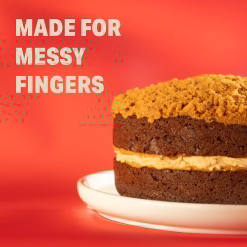 Close-up of chocolate biscoff cake with the words 'made for messy fingers' overlayed