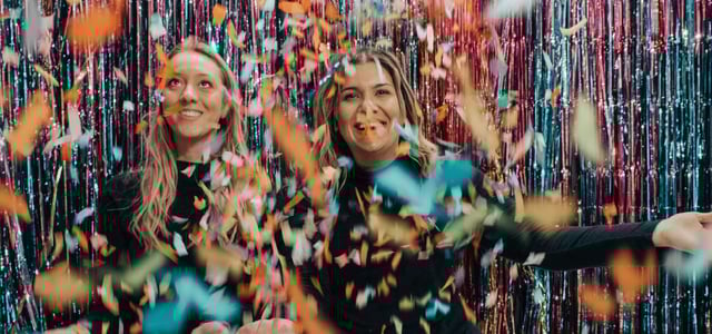 Two women celebrating with confetti