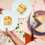 Vegan Victoria Sponge Cake - Whole on cake stand with cake knife about to cut it