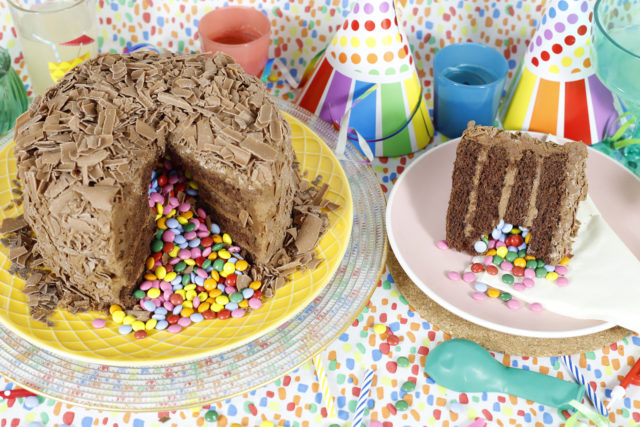Whole Birthday Cakes - Picture of our Pinata cake, a chocolate cake covered in chocolate flakes, with a surprise inside of multicolour chocolate beans